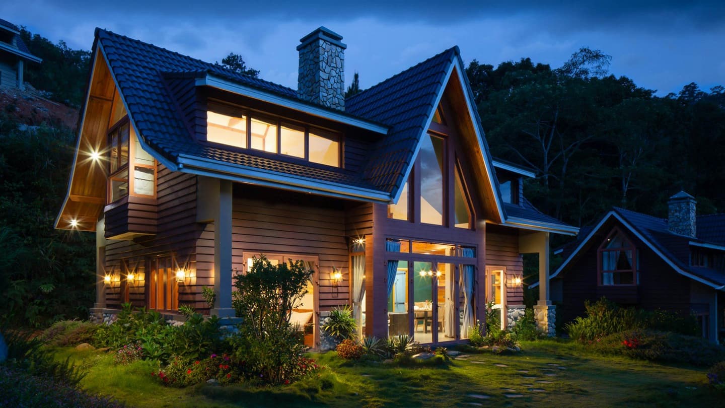 Well-kept home lit at dusk in a neighborhood we serve